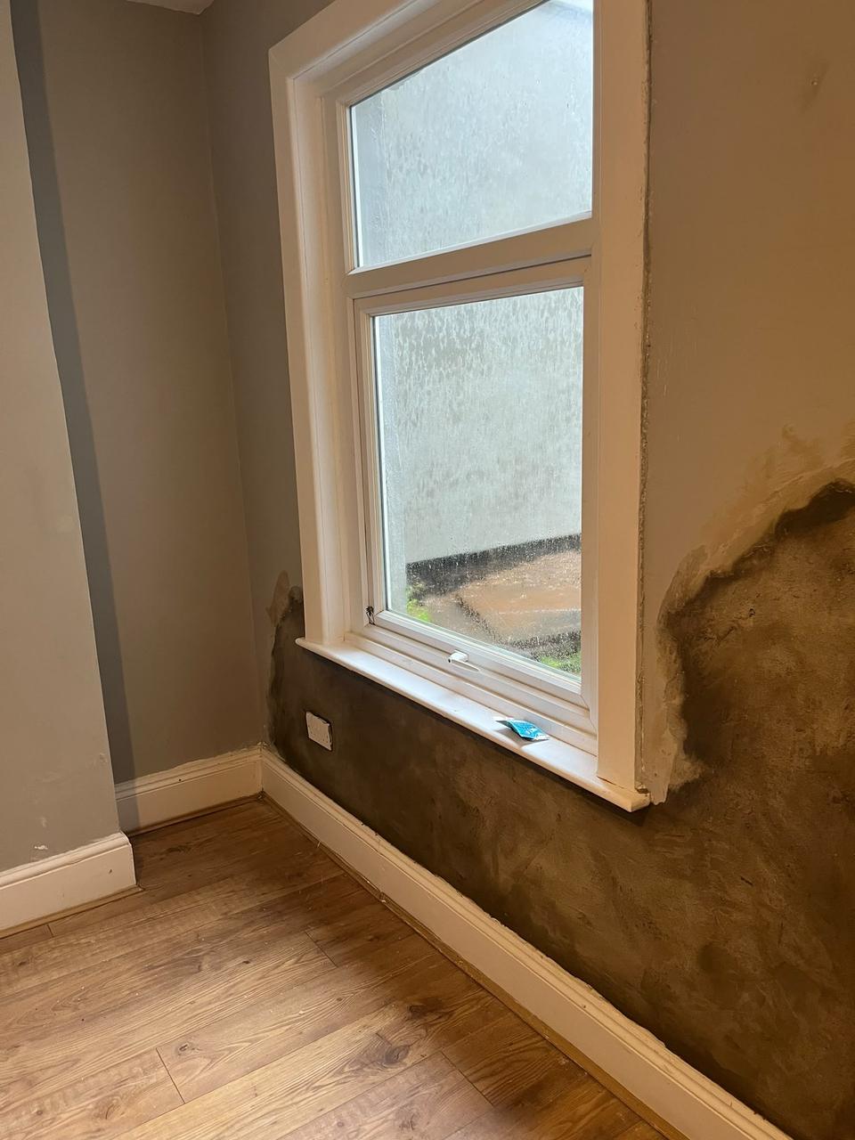 Interior wall stripped back and rendered