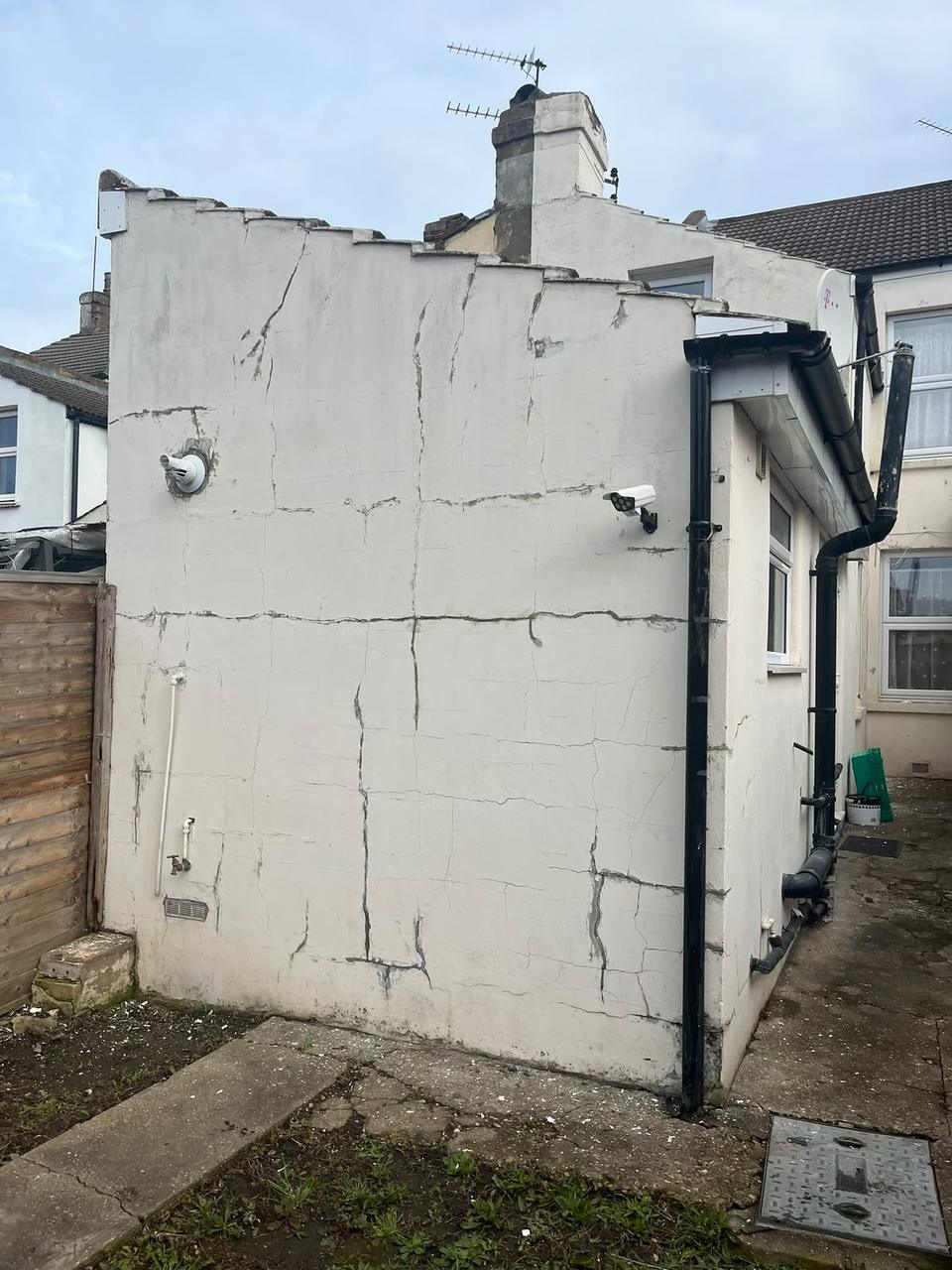 Rear elevation with badly cracked render