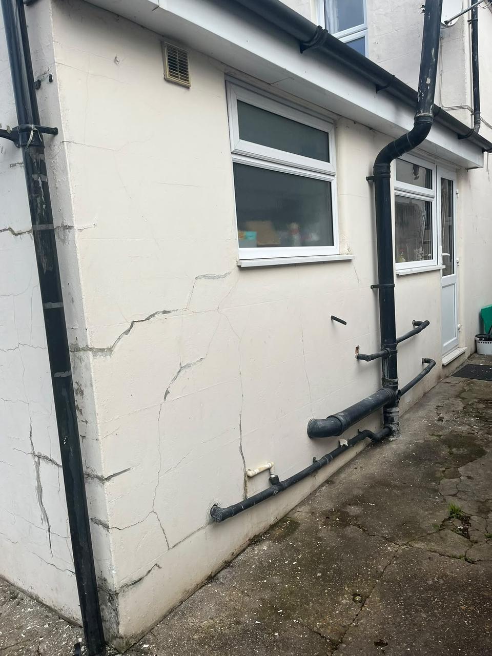 Side wall with cracking around waste pipes